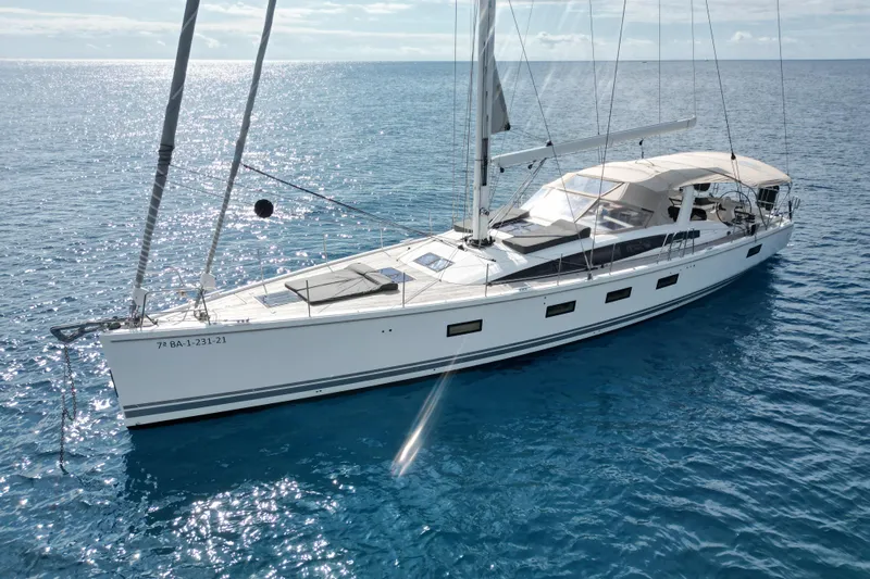  Yacht Photos Pics Luxurious 2015 Jeanneau Yachts 64 sailing on clear blue ocean waters.