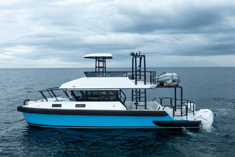  Yacht Photos Pics 2023 Vandal 46 Explorer yacht cruising on open sea under cloudy skies.