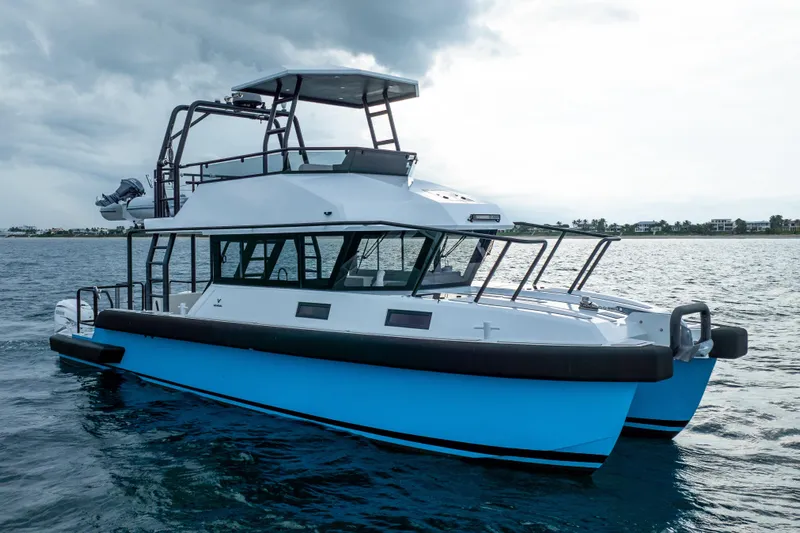  Yacht Photos Pics 2023 Vandal 46 Explorer catamaran on open water under cloudy skies.