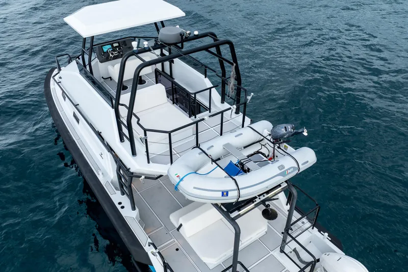  Yacht Photos Pics 2023 Vandal 46 Explorer yacht with inflatable boat on deck, cruising on open water.