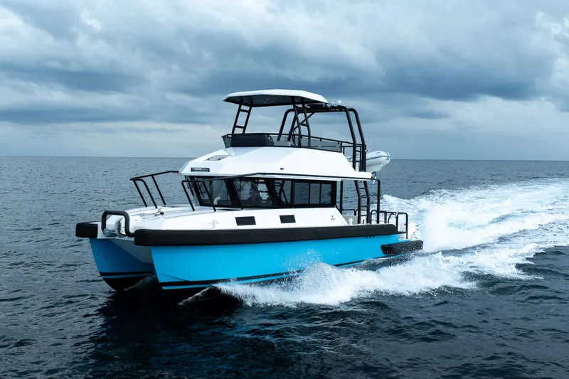  Yacht Photos Pics 2023 Vandal 46 Explorer cruising on open sea under cloudy skies.