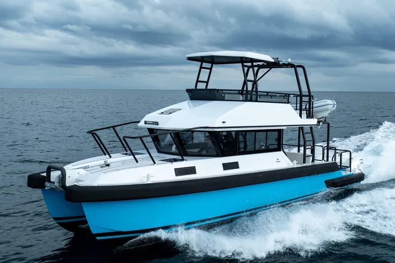  Yacht Photos Pics 2023 Vandal 46 Explorer yacht cruising on open sea under cloudy skies.