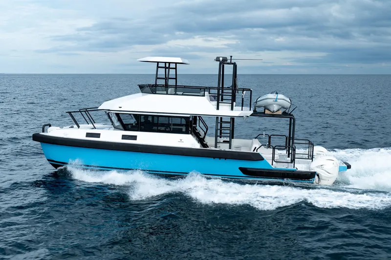  Yacht Photos Pics 2023 Vandal 46 Explorer cruising on open sea under cloudy skies.