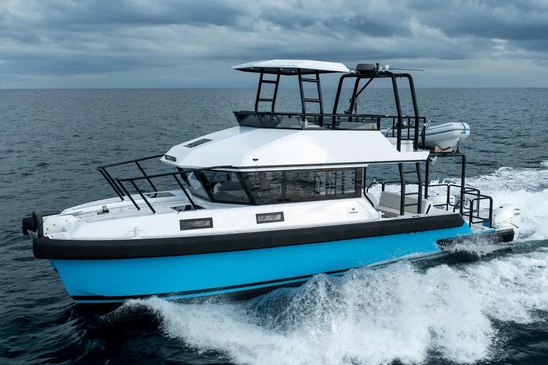  Yacht Photos Pics 2023 Vandal 46 Explorer yacht cruising on open sea under cloudy skies.