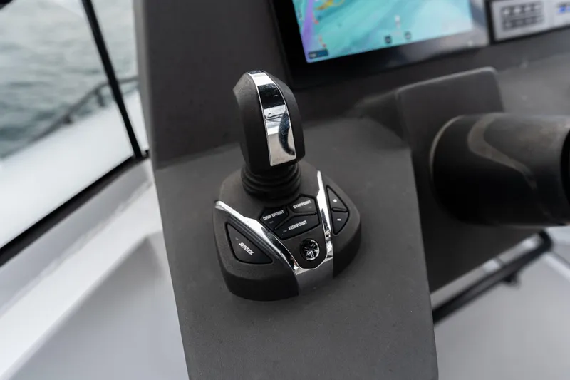  Yacht Photos Pics Joystick control on 2023 Vandal 46 Explorer boat dashboard with navigation screen.