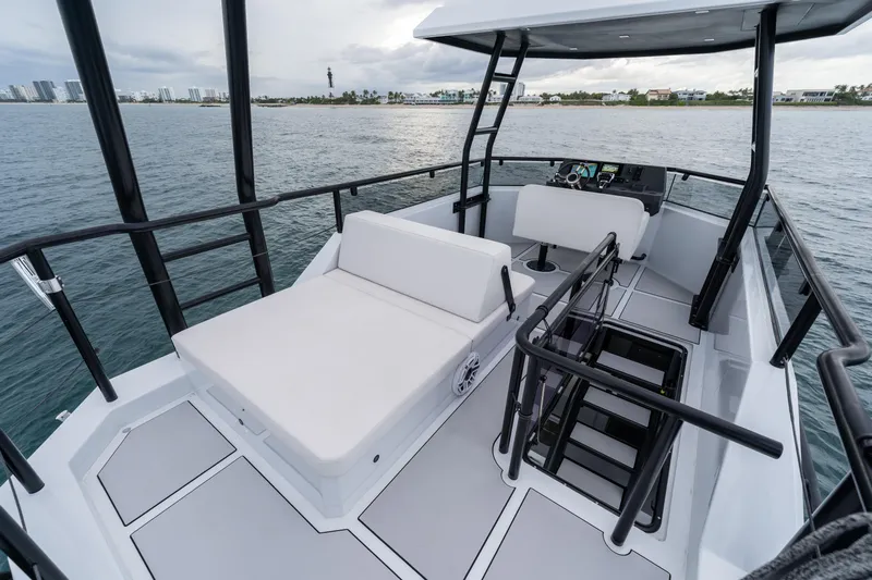  Yacht Photos Pics 2023 Vandal 46 Explorer yacht interior with seating, railing, and ocean view.