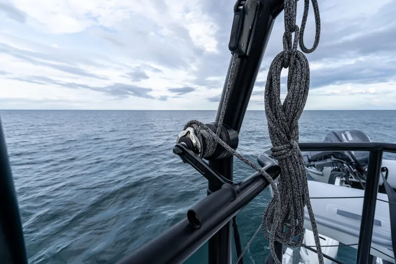  Yacht Photos Pics 2023 Vandal 46 Explorer yacht detail with ocean backdrop and rigging ropes.