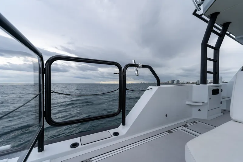  Yacht Photos Pics 2023 Vandal 46 Explorer yacht deck with ocean view and city skyline.