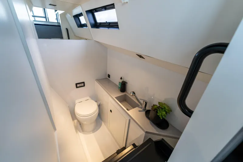  Yacht Photos Pics Modern bathroom interior on 2023 Vandal 46 Explorer yacht, featuring sleek design and compact amenities.