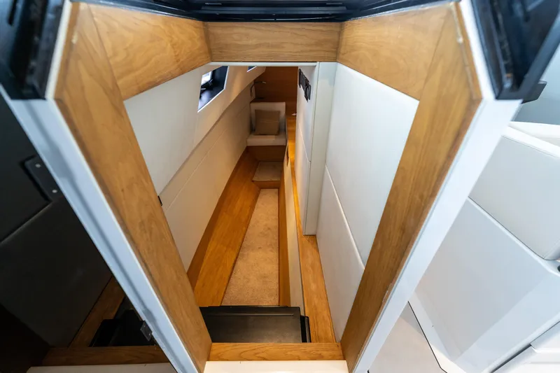  Yacht Photos Pics Interior view of 2023 Vandal 46 Explorer yacht, featuring sleek wooden and white paneling.