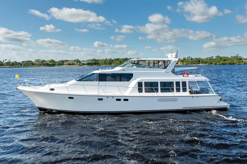 Last Call Yacht Photos Pics 2009 Pacific Mariner 65 Motoryacht cruising on a sunny day with blue skies.