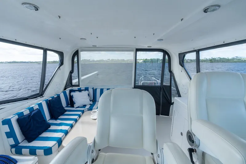 Last Call Yacht Photos Pics Interior of 2009 Pacific Mariner 65 Motoryacht with striped seating and water view.