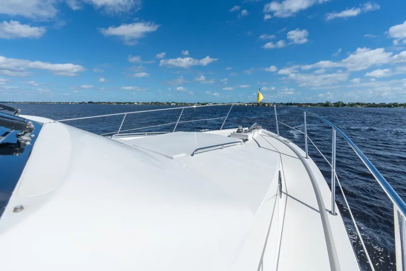 Last Call Yacht Photos Pics 2009 Pacific Mariner 65 Motoryacht cruising on open water under blue skies.