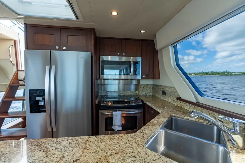 Last Call Yacht Photos Pics Luxurious kitchen interior of 2009 Pacific Mariner 65 Motoryacht with stainless steel appliances.