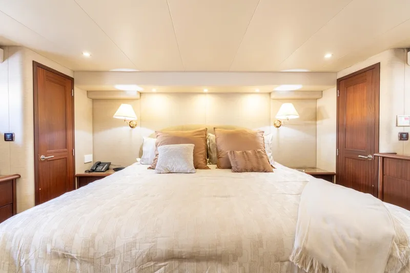 Last Call Yacht Photos Pics Luxurious bedroom interior of 2009 Pacific Mariner 65 Motoryacht with elegant bedding and lighting.