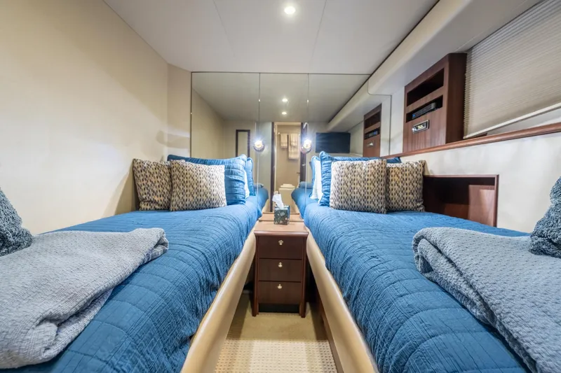 Last Call Yacht Photos Pics Luxurious twin cabin in 2009 Pacific Mariner 65 Motoryacht with blue bedding and elegant decor.