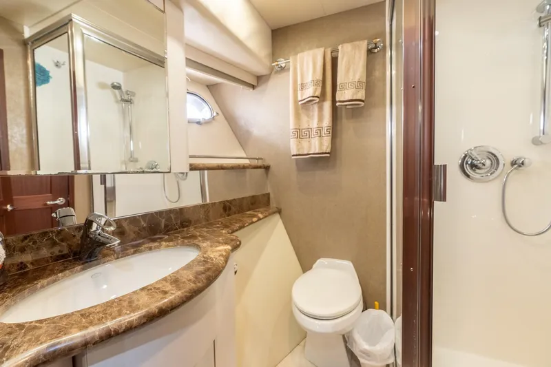 Last Call Yacht Photos Pics Luxurious bathroom in 2009 Pacific Mariner 65 Motoryacht with marble countertop and shower.