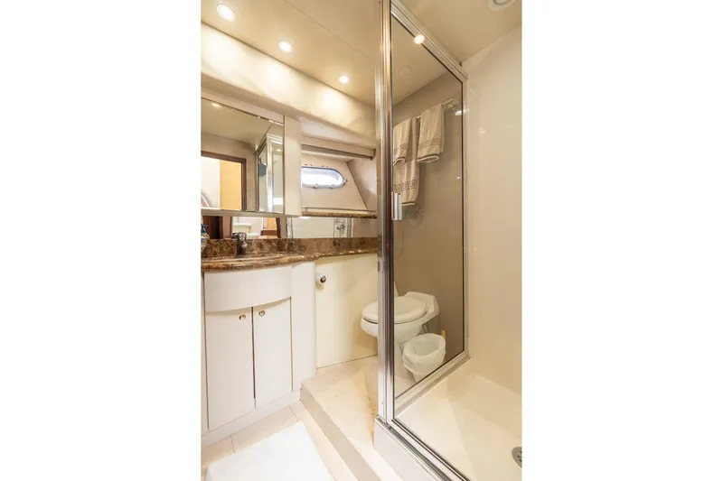Last Call Yacht Photos Pics Luxurious bathroom in 2009 Pacific Mariner 65 Motoryacht with marble countertop and glass shower.