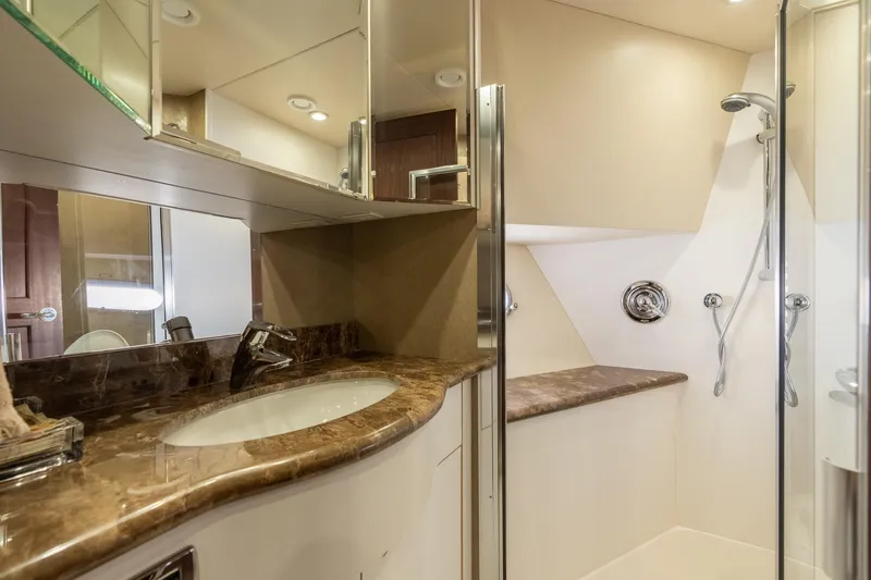 Last Call Yacht Photos Pics Luxurious bathroom in 2009 Pacific Mariner 65 Motoryacht with marble countertop and glass shower.