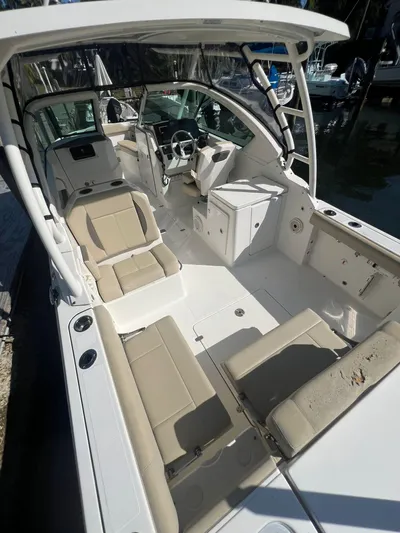 Yacht Photos Pics 2020 Pursuit 266 boat interior with beige seating and modern helm.