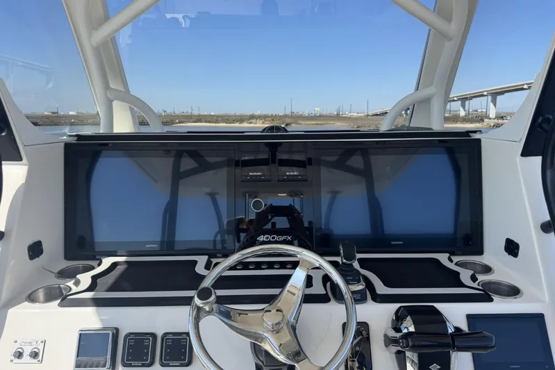 The Madd House Yacht Photos Pics 2023 Twin Vee 400 GFX CC boat dashboard with modern controls and dual Garmin screens.