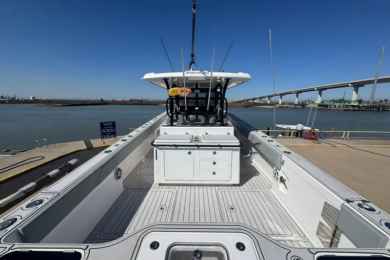 The Madd House Yacht Photos Pics 2023 Twin Vee 400 GFX CC boat docked, showcasing spacious deck and modern design.