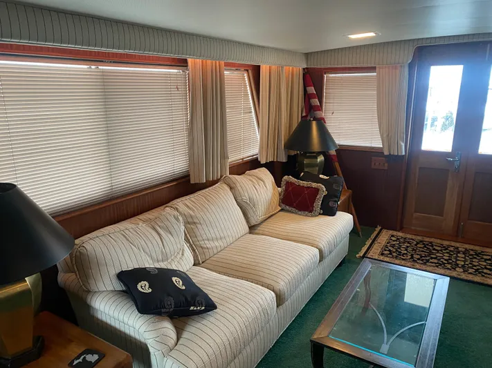 Yacht Photos Pics Interior of 1983 Hatteras 53 Motor Yacht with cozy seating and nautical decor.