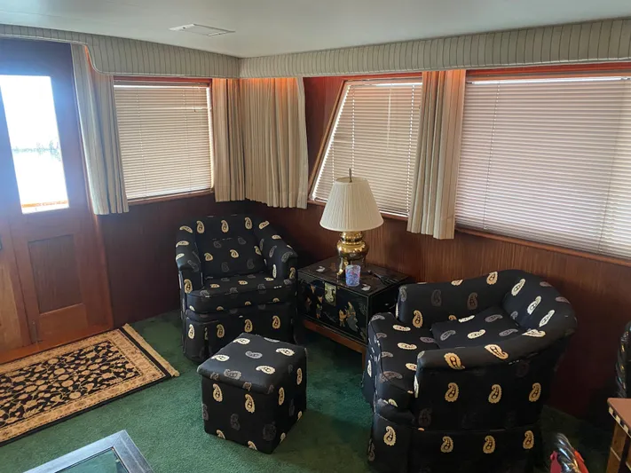  Yacht Photos Pics Interior of 1983 Hatteras 53 Motor Yacht with patterned chairs and elegant decor.