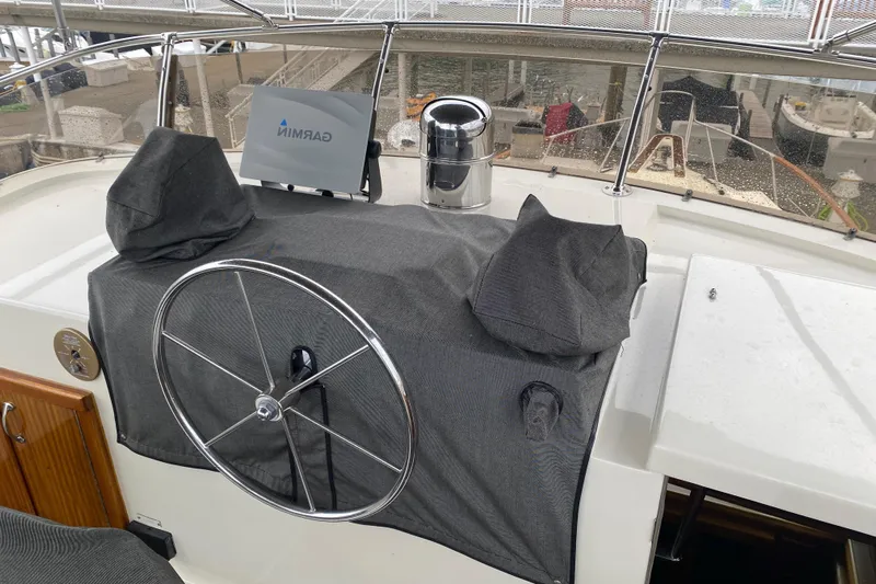  Yacht Photos Pics 1983 Hatteras 53 Extended Deckhouse Motor Yacht helm with covered controls and navigation equipment.