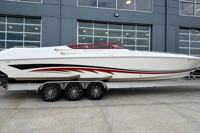  Yacht Photos Pics 2007 Fountain 38 Lightning speedboat on trailer, sleek design with red and black accents.