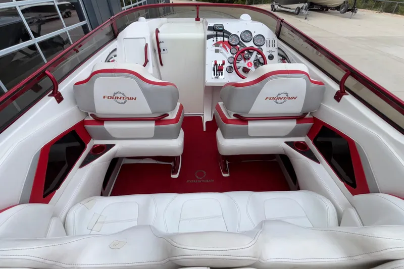  Yacht Photos Pics 2007 Fountain 38 Lightning boat interior with white and red seating, dashboard, and controls.