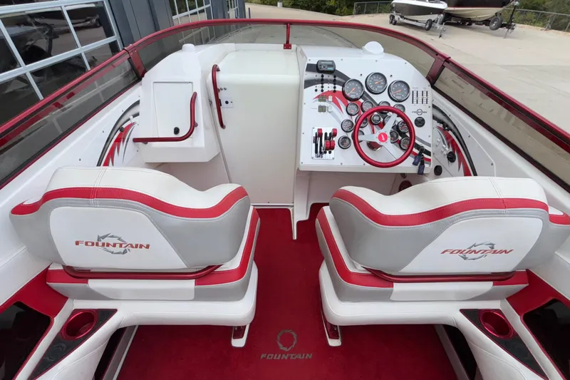 Yacht Photos Pics 2007 Fountain 38 Lightning boat cockpit with red and white interior, dual seats, and control panel.