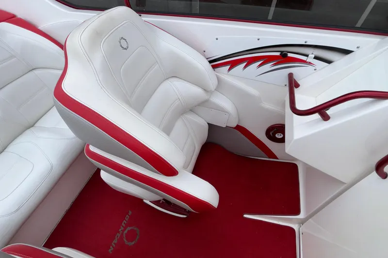  Yacht Photos Pics 2007 Fountain 38 Lightning boat interior with white and red seating and carpet.