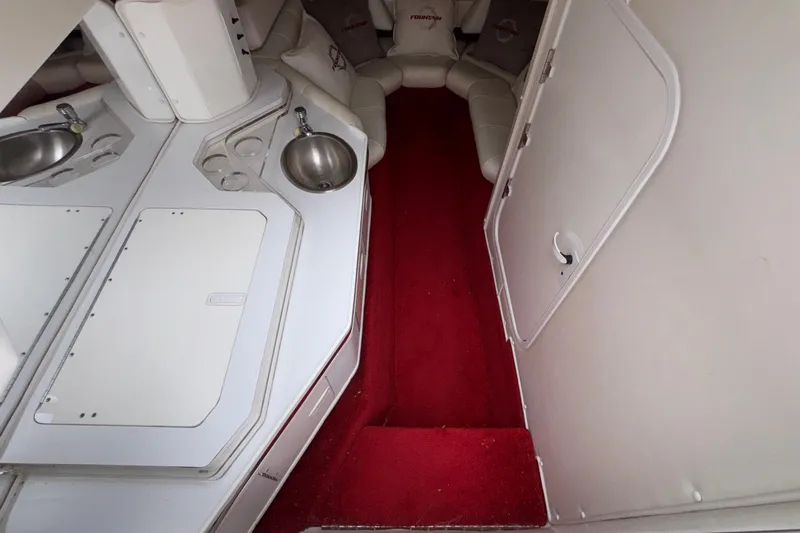  Yacht Photos Pics Interior of 2007 Fountain 38 Lightning boat with red carpet and white seating.