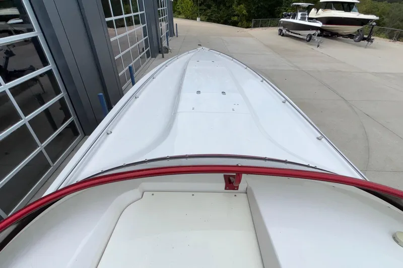  Yacht Photos Pics 2007 Fountain 38 Lightning boat on a concrete driveway near a garage.