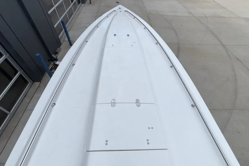  Yacht Photos Pics 2007 Fountain 38 Lightning boat deck, sleek design, parked on concrete surface.