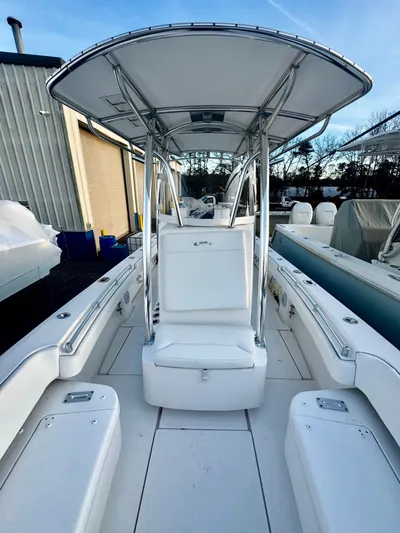  Yacht Photos Pics 2024 Contender 25 Tournament CC boat with T-top and seating, docked outdoors.