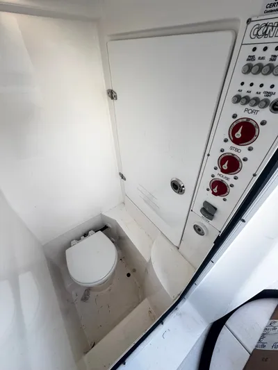 Yacht Photos Pics 2024 Contender 25 Tournament CC boat interior with toilet and control panel.