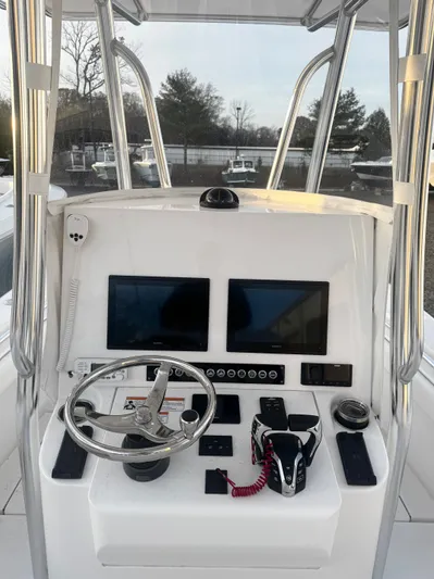  Yacht Photos Pics 2024 Contender 25 Tournament CC boat console with dual screens and steering wheel.