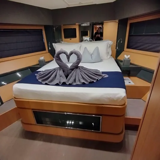 Silver Breeze Yacht Photos Pics Luxurious bedroom interior of 2010 Riva 86 Domino yacht with elegant towel swans on bed.