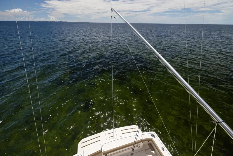 Mutiny Yacht Photos Pics Tiara Yachts 4200 Open 2004 on open sea, fishing rods in use.