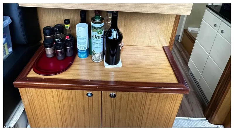  Yacht Photos Pics Wooden cabinet with bottles and spices on a 2008 Ferretti Yachts 731.