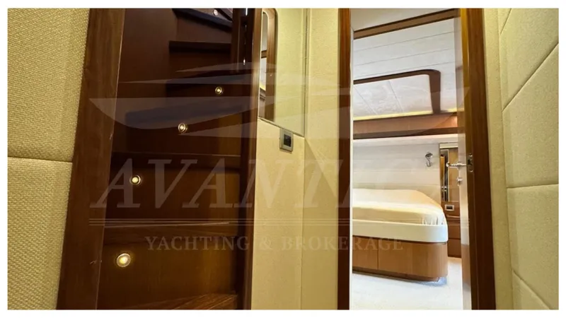  Yacht Photos Pics Luxurious interior of 2008 Ferretti Yachts 731, featuring elegant wood staircase and cozy bedroom.