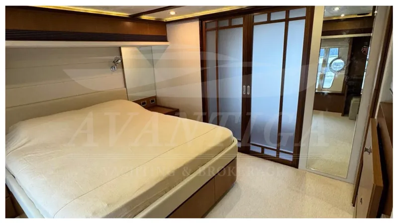  Yacht Photos Pics Luxurious bedroom interior of 2008 Ferretti Yachts 731 with elegant wood accents.