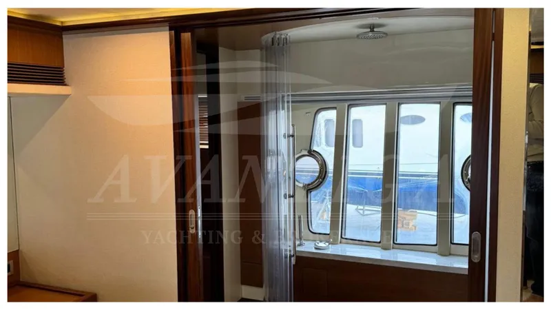  Yacht Photos Pics Interior view of 2008 Ferretti Yachts 731, featuring elegant wood finishes and large windows.
