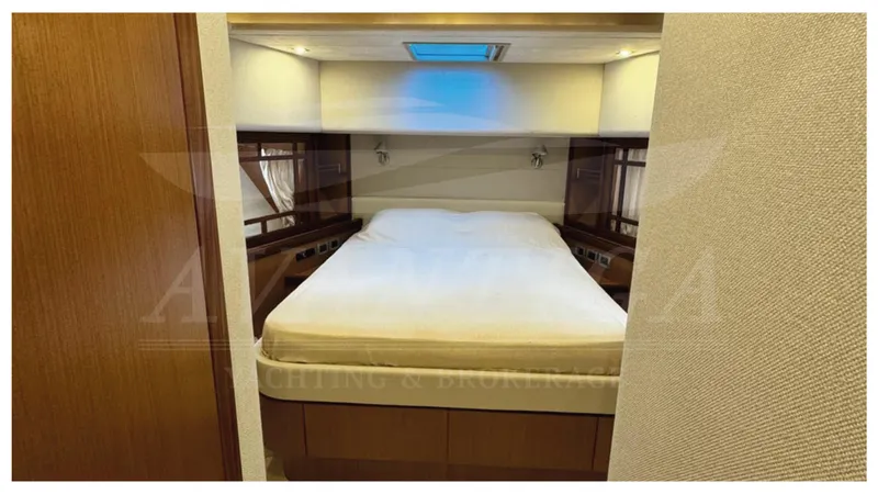  Yacht Photos Pics Luxurious bedroom interior of 2008 Ferretti Yachts 731 with skylight and wood accents.