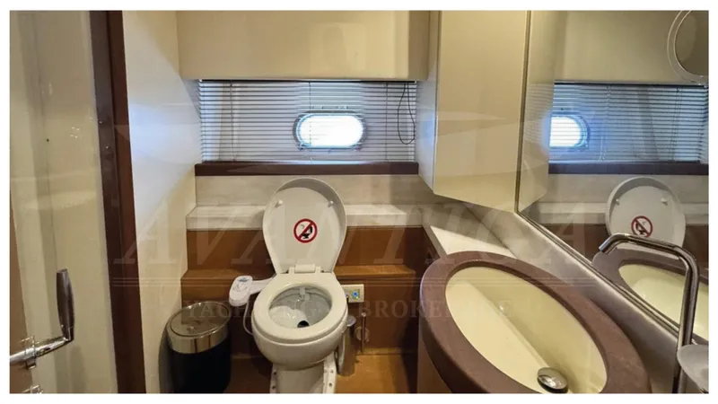  Yacht Photos Pics Luxury bathroom in 2008 Ferretti Yachts 731, featuring modern fixtures and porthole window.