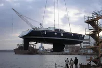 Motorsailer ВС-1800С 2007 being lifted by crane at shipyard, with industrial background.