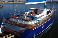 Blue and white 2007 Motorsailer ВС-1800С docked in a marina.