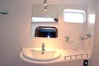 Bathroom interior of 2007 Motorsailer ВС-1800С with sink, mirror, and window.